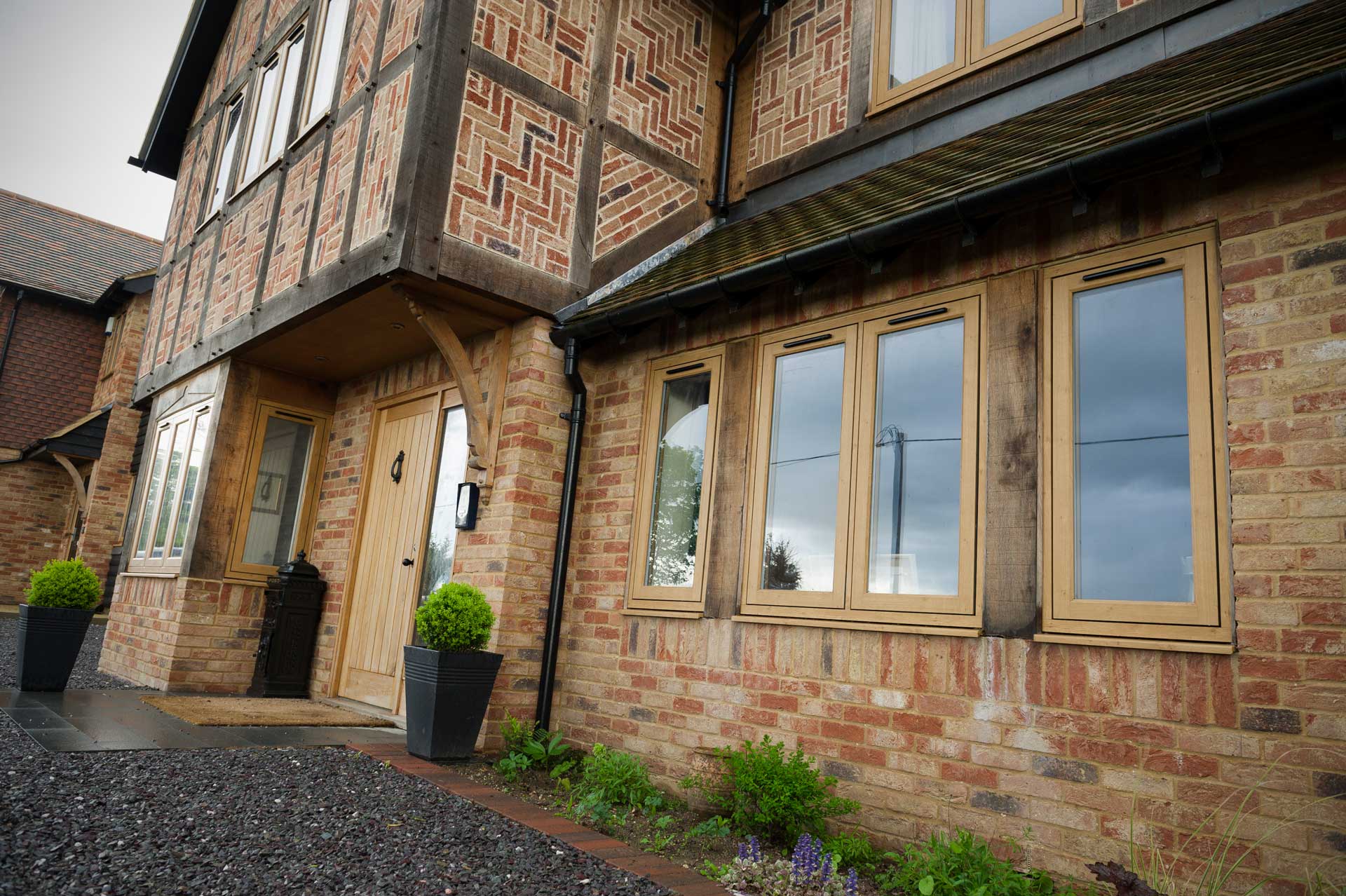 Residence 9 Windows Surrey on front of house with potted plants next to front door