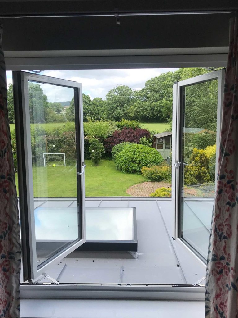 Open double glazed windows with large glass panels opening up to roof