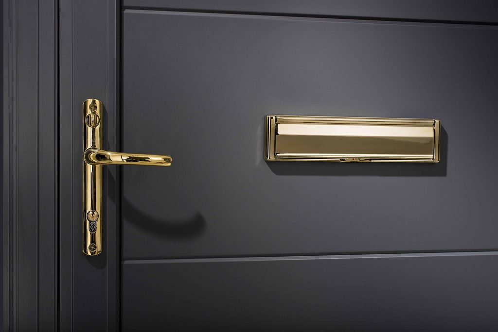 close up of an origin entrance door with gold hardware