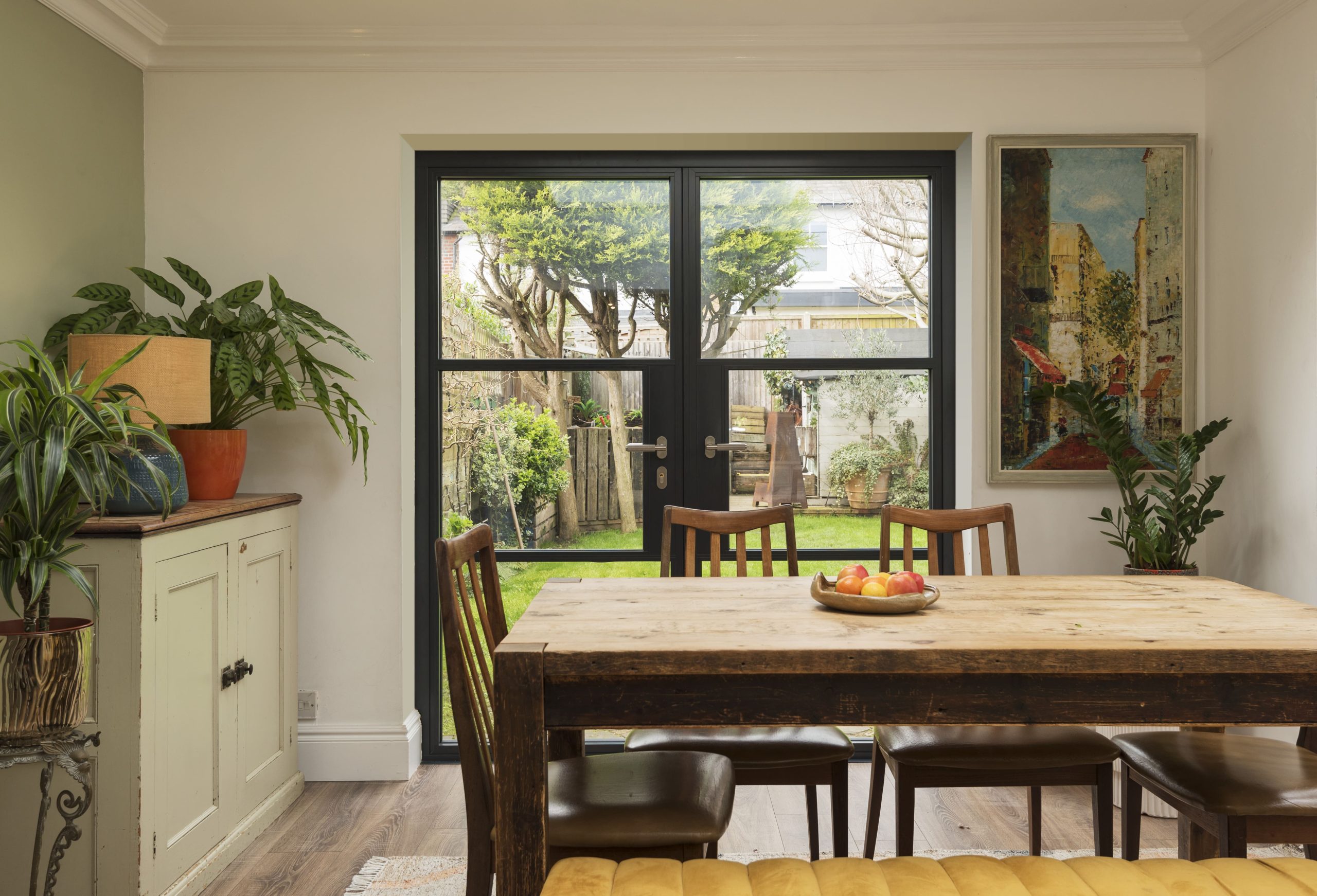 aluminium french door dining room facing a back garden