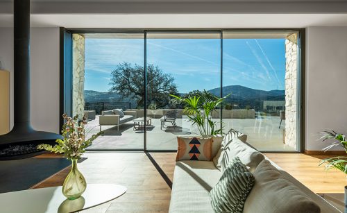 A triple patio door looking out on a garden.